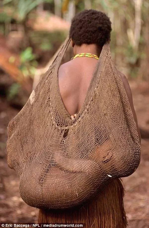A Korowai tribeswoman carrying a baby on her back. Photo: Eric Baccega A Korowai tribeswoman carrying a baby on her back. Photo: Eric Baccega