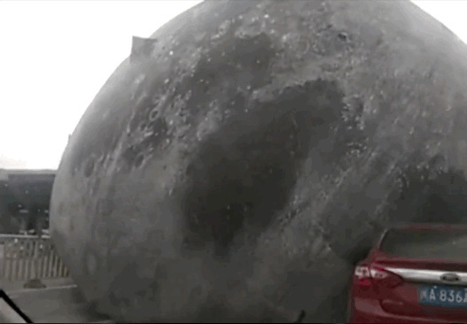 Giant moon ball smashes cars on busy Chinese road Giant moon ball smashes cars on busy Chinese road