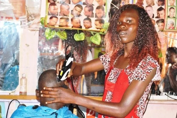 Woman, 25, dropped out of school but now owns her own salon and barber shop (photo)