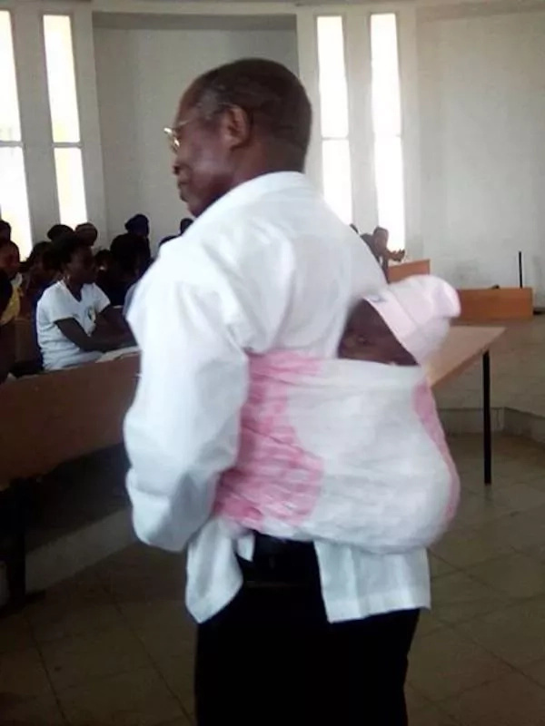 This is reportedly Professor Honore Kahi of Ivory Coast. He is seen carrying his student’s baby on his back This is reportedly Professor Honore Kahi of Ivory Coast. He is seen carrying his student’s baby on his back
