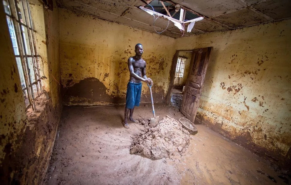 Abdul Mansaray gathers the mud in his house. Photo: BBC Abdul Mansaray gathers the mud in his house. Photo: BBC