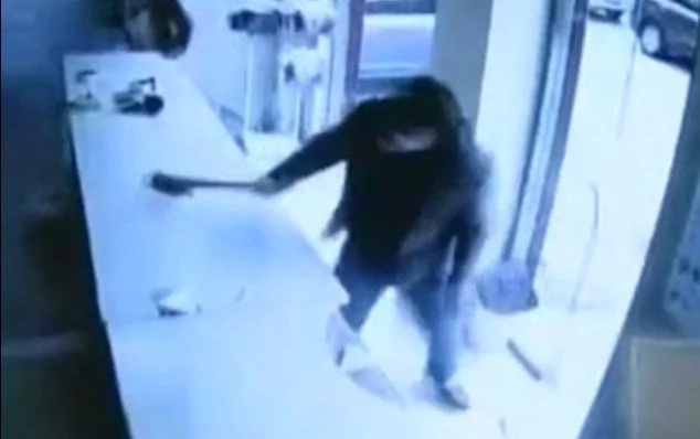 Shocking moment an angry man leads a club-wielding gang to smash a laundry shop after 'they destroyed his favourite cardigan' Shocking moment an angry man leads a club-wielding gang to smash a laundry shop after 'they destroyed his favourite cardigan'