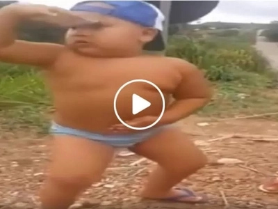 Energetic young boy hilariously shows off dancing prowess by the street
