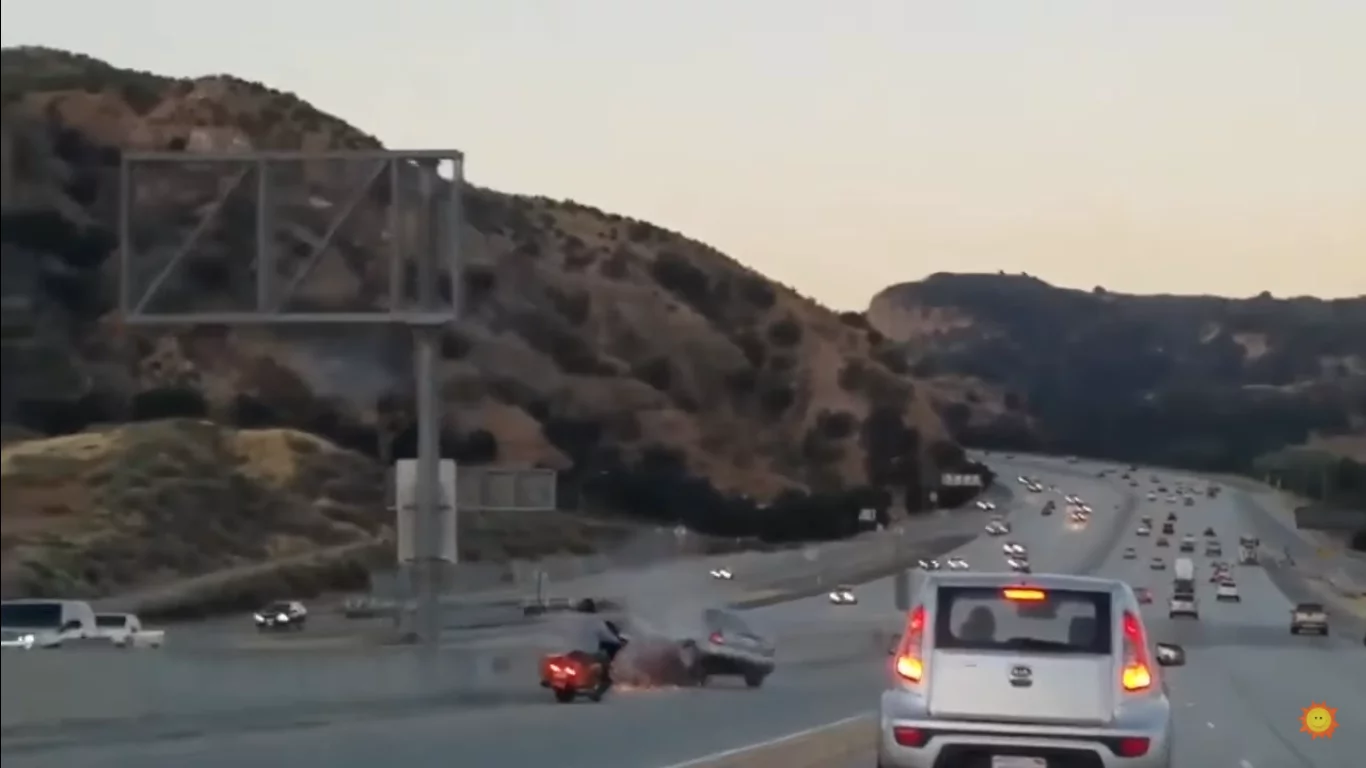 This raged biker kicked a car - which then swooped left for revenge, but it horribly goes wrong This raged biker kicked a car - which then swooped left for revenge, but it horribly goes wrong