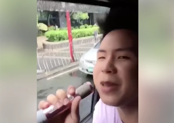 Filipino entertains by singing to the public inside a car while traffic Filipino entertains by singing to the public inside a car while traffic