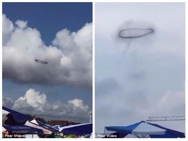 Is that a UFO? Swimmers puzzled by black ring that hovered in the clouds above the beach