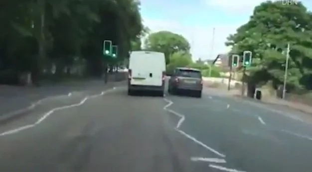2 Enraged drivers in a road range race in a school street. Reckless driving caught by a motorist's dash cam. 2 Enraged drivers in a road range race in a school street. Reckless driving caught by a motorist's dash cam.