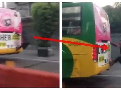 Kapit lang! Man latches on the back of a bus along EDSA
