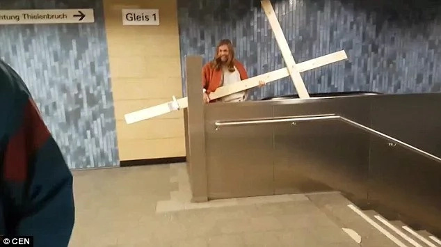 Funny moment as man dressed as Jesus gets his cross STUCK in the ceiling (photos, video) Funny moment as man dressed as Jesus gets his cross STUCK in the ceiling (photos, video)