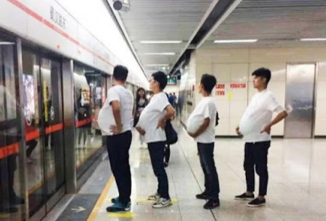 Are these men pregnant? No, they just support their wives! Are these men pregnant? No, they just support their wives!