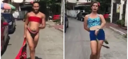 Two bekis walk the streets in heels mimicking Miss Universe's swimsuit competition