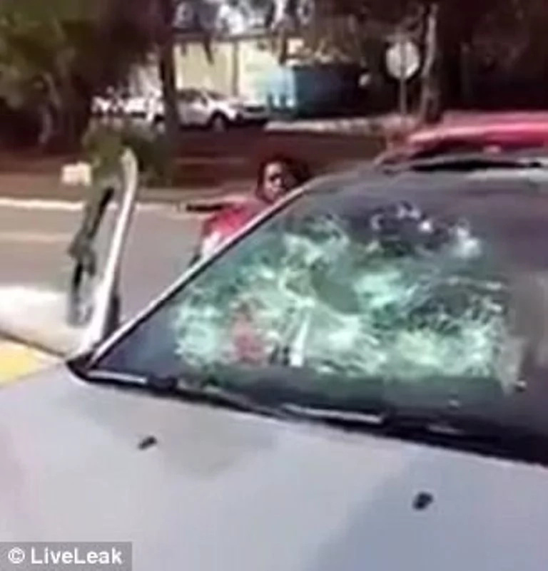 It's over 'beb'! Woman goes completely berserk, smashes ex-lover's car with hammer in REVENGE