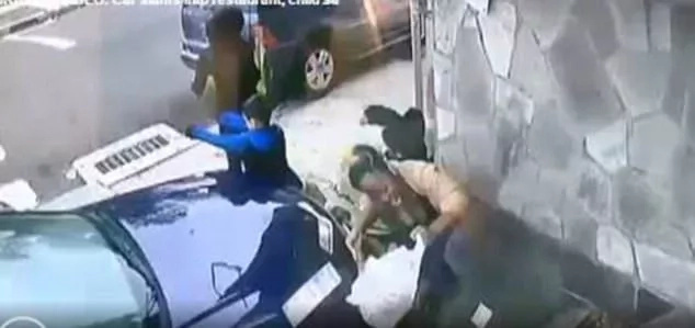 Brave woman shields boy from impact of car that rammed into wall Brave woman shields boy from impact of car that rammed into wall