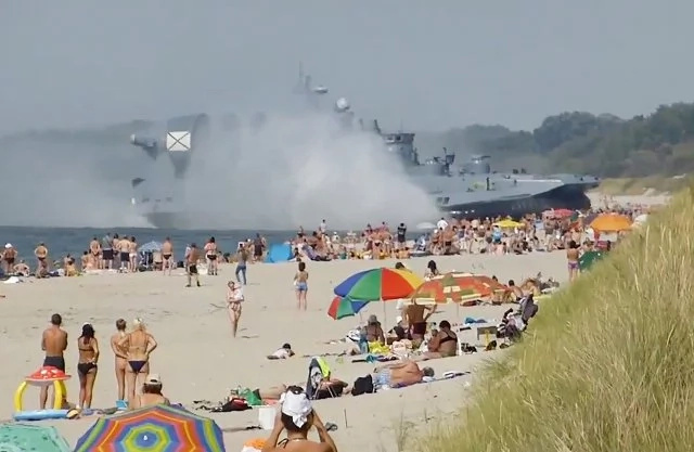 Amazing Video Of Military Hovercraft Pushing Across Beach Full Of People! Amazing Video Of Military Hovercraft Pushing Across Beach Full Of People!