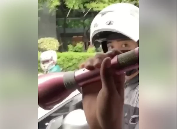 Filipino entertains by singing to the public inside a car while traffic Filipino entertains by singing to the public inside a car while traffic