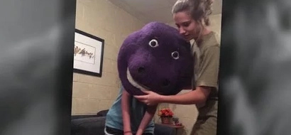WATCH: Friends film teenager with Barney mask stuck on head