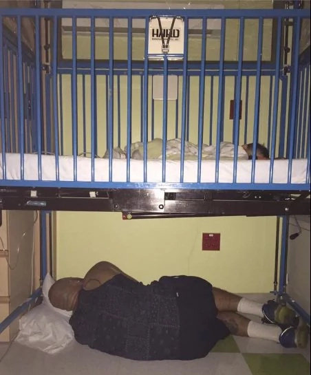 Father sleeps under child’s crib in hospital Father sleeps under child’s crib in hospital