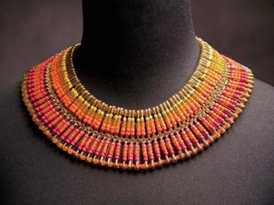 The woman takes beads and puts them on pins. What she creates is so pretty and amazing!