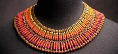 The woman takes beads and puts them on pins. What she creates is so pretty and amazing!