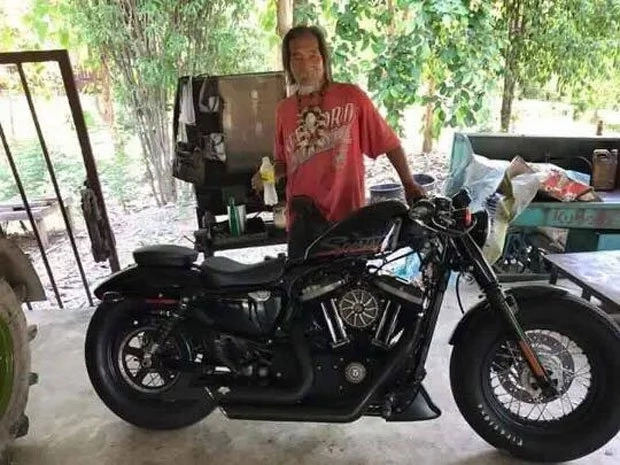 Rich man in tattered clothing buys Harley Davidson in cash Rich man in tattered clothing buys Harley Davidson in cash