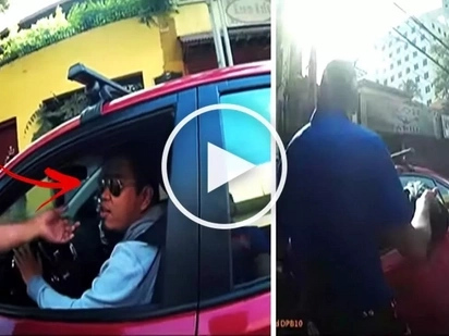 Watch this Pinoy driver attempt to run over traffic enforcers who apprehended him for allegedly beating the red light! What a terrifying video!