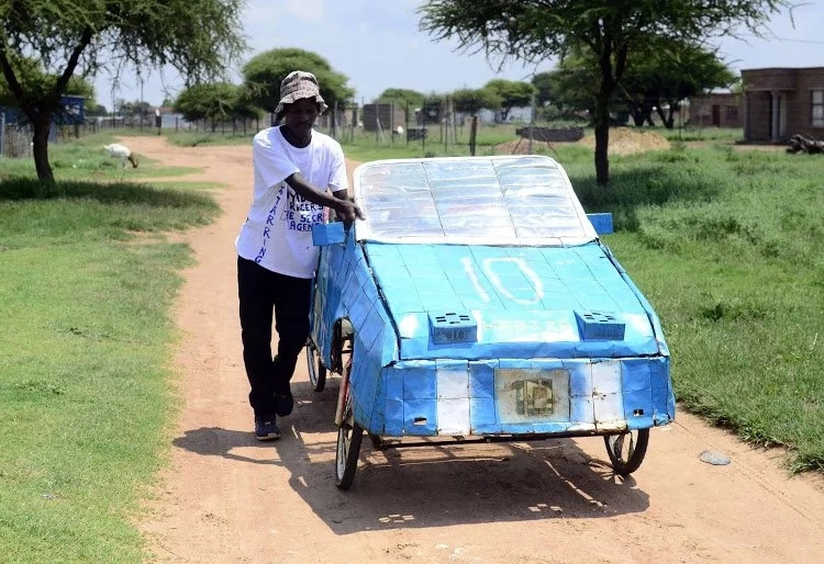 Patrick Chweu stands next to his "bicycle-car." Source: Sowetan Patrick Chweu stands next to his "bicycle-car." Source: Sowetan