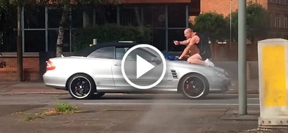 Outraged man jumps on the car and headbutts its windscreen. What driver does will surprise you!