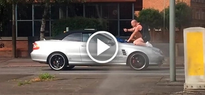 Outraged man jumps on the car and headbutts its windscreen. What driver does will surprise you!