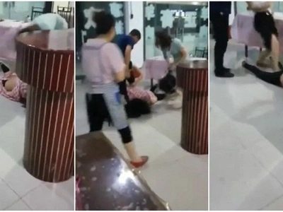 Bizarre moment Chinese mistress attacked by two furious wives in a restaurant