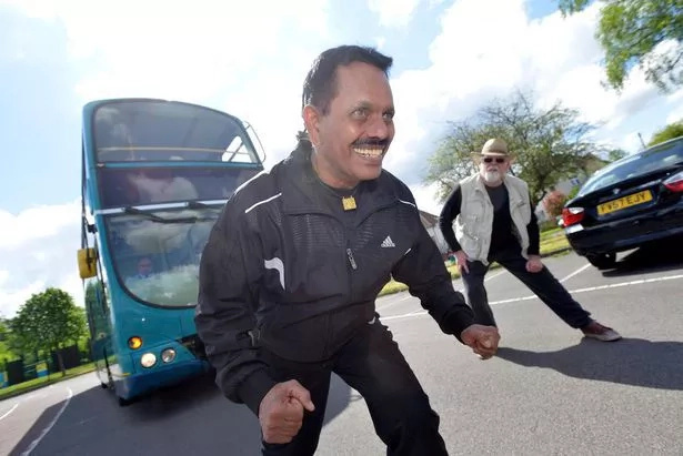 Grandad breaks own world record, pulls giant bus with ponytail