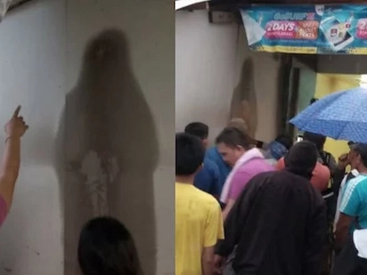 Miracle or creepy? People are worshiping this black figure on the wall that looks like Mama Mary