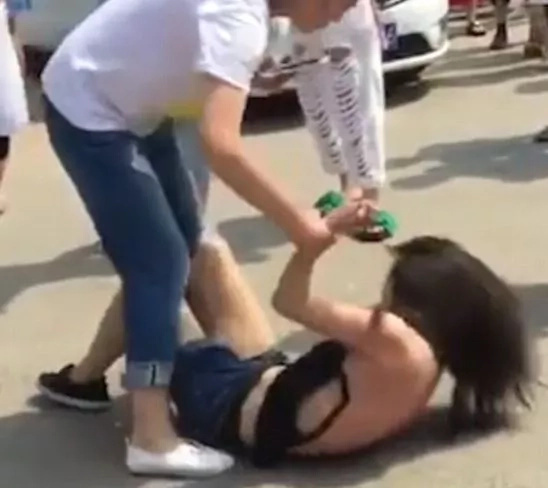 Angry woman beats, strips husband's mistress in public