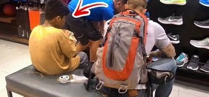 A tatooed foreigner enters the mall with a barefooted street kid at night. They entered a shoe store and started grabbing several pairs of shoes!