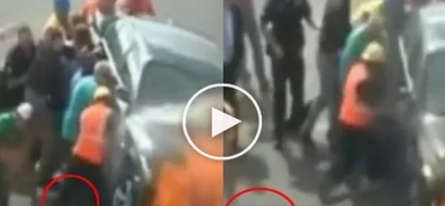 This driver was pulled from under the burning car by a group of strangers
