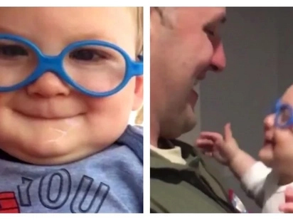 Visually disabled infant sees his father's face for the first time with new glasses!