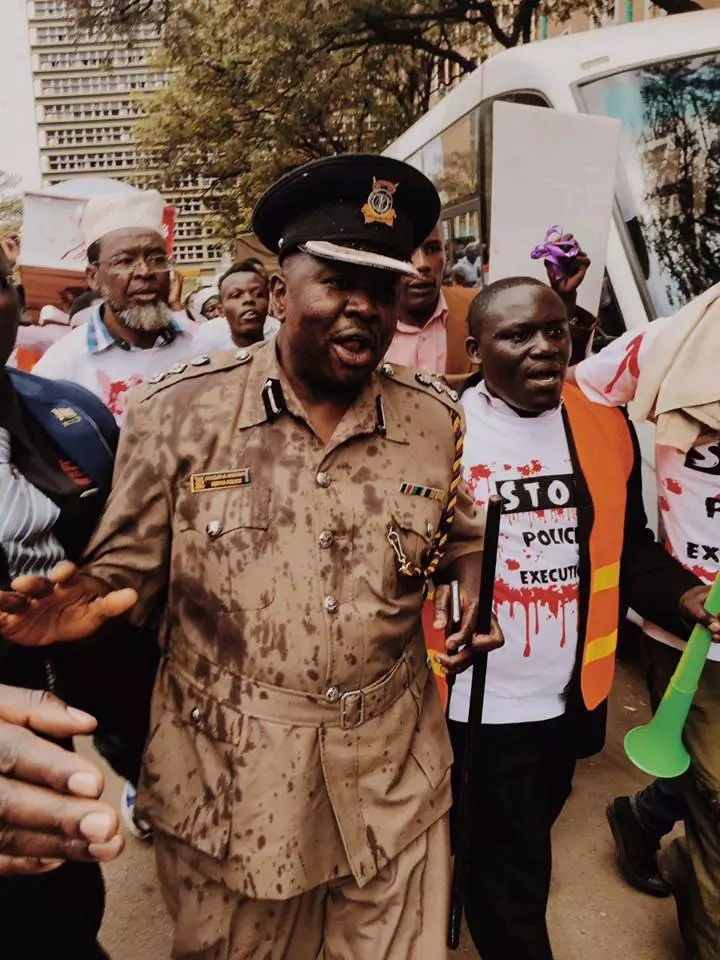 Protestors pour red paint on police spokesperson Charles Owino