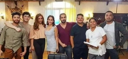 Something strange was captured in this group photo. Can you spot where the ghost is?