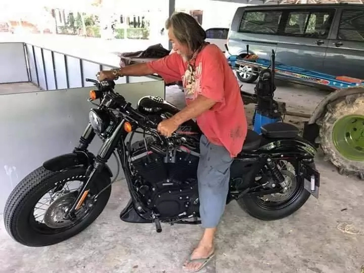 Rich man in tattered clothing buys Harley Davidson in cash Rich man in tattered clothing buys Harley Davidson in cash
