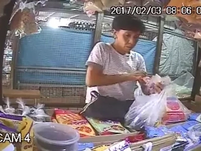 Act of stealing by an old woman who keeps on talking in order to distract the seller caught on CCTV