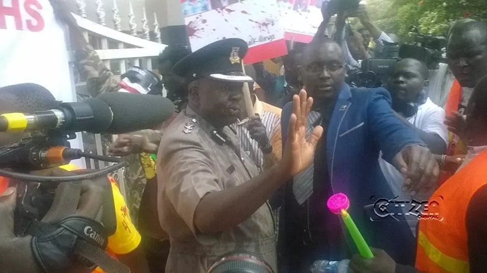 Protestors pour red paint on police spokesperson Charles Owino