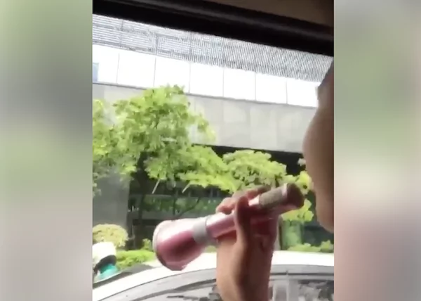 Filipino entertains by singing to the public inside a car while traffic Filipino entertains by singing to the public inside a car while traffic