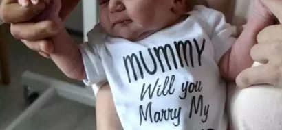 Mom gasps when boyfriend hands her newborn son with marriage proposal on his onesie