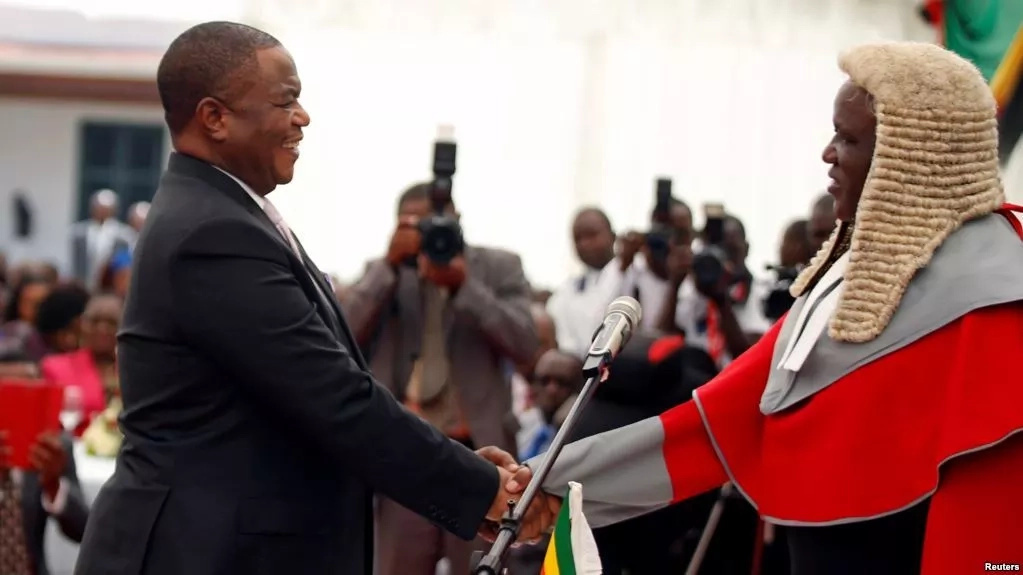 Zimbabwe's ex-army boss sworn in as VP; Mugabe gets diplomat's rights Zimbabwe's ex-army boss sworn in as VP; Mugabe gets diplomat's rights