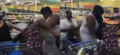 Two women fight over the last box of water before hurricane Matthew strikes